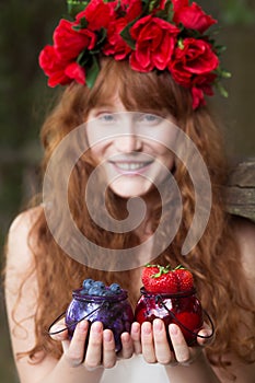 Woman with jars with seasonal fruits