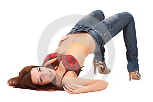 Woman in jeans lies on a white