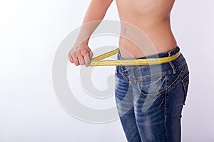 Woman in jeans with a tape measure