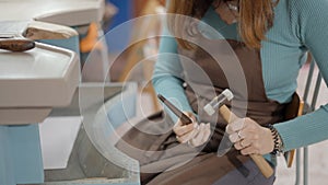 Woman Jeweller Hammering A Ring At Her Workshop Place. Close Up