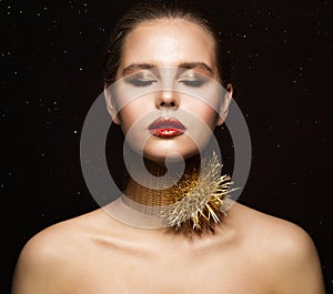 Woman Jewelry Necklace. Fashion Girl in Gold Collar with Thorns. Eyes closed Model in golden Makeup. Black Background