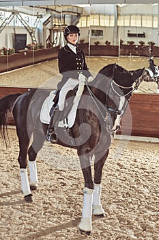 Woman jockey with his horse