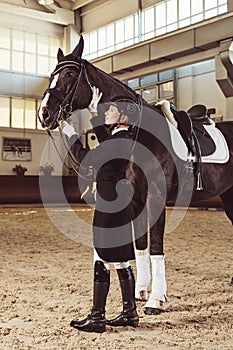 Woman jockey with his horse