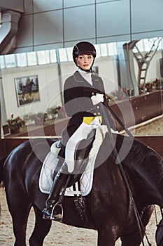 Woman jockey with his horse