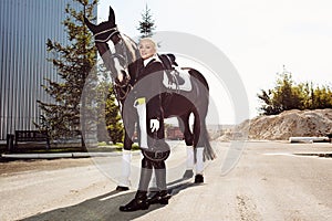 Woman jockey with his horse