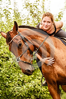 Woman jockey training riding horse. Sport activity