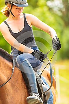 Woman jockey training riding horse. Sport activity