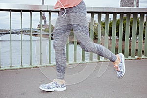 Woman jogger against clear view of Eiffel Tower running