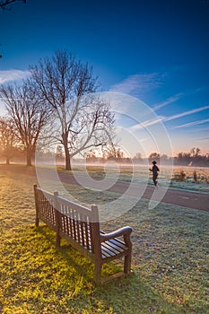 Woman Jogger during a morning winter jog at a park