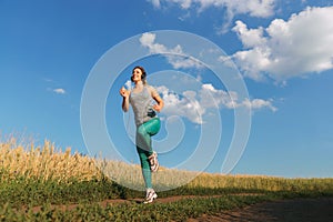 Woman jogger working out in the morning sunny day