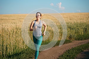 Woman jogger working out in the morning sunny day