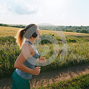 Woman jogger working out in the morning sunny day