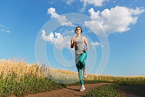 Woman jogger working out in the morning sunny day