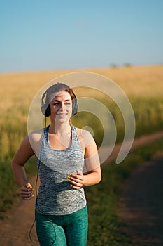 Woman jogger working out in the morning sunny day