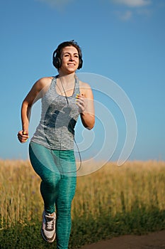 Woman jogger working out in the morning sunny day