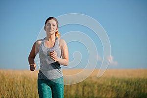Woman jogger working out in the morning sunny day