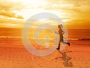 Woman jogging alone at beautiful sunset in the beach