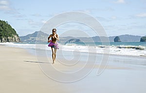 Woman jogging along a beautiful beach.