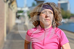 Woman jogging alongside an urban canal or river