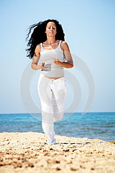 Woman jogging on the beach.