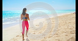 Woman jogging in the beach 4k