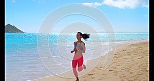 Woman jogging in the beach 4k