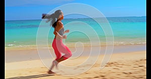 Woman jogging in the beach 4k