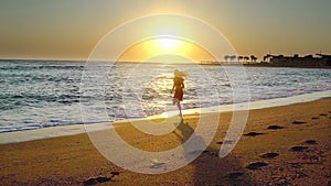 Woman jogging on beach sea and sunrise