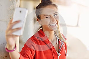 Woman jogging on the beach with smartphone