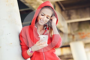 Woman jogging on the beach with smartphone