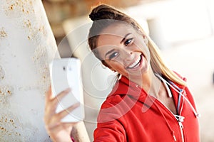 Woman jogging on the beach with smartphone