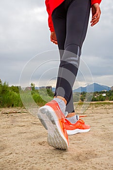 Woman jogging down an outdoor trail at sunset