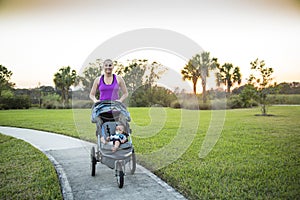 Woman jogging and exercising outdoors while pushing her baby in a stroller