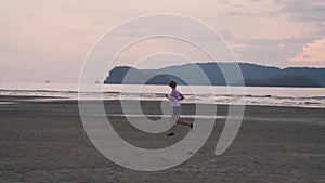 Woman Jogging by the Ocean Beach