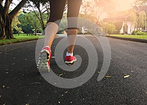 Woman jogging in park at sunlight in the morning