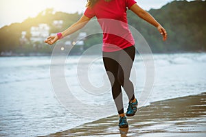 Woman jogging workout on the beach in the morning. Relax with the sea walk. Jump up and fun on workout