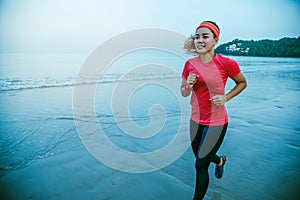 Woman jogging workout on the beach in the morning. Relax with the sea walk. in summer