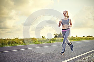 Woman jogs runs on nature
