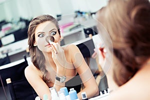 Woman joking in front of a mirror