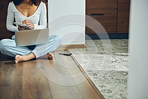 Woman jotting down her ideas in a notebook