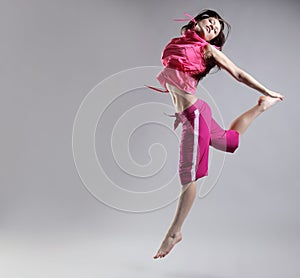 Woman jump. Beauty girl dance on grey background