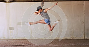 Woman, jump and dance for freedom by outside on street for practice of routine for competition. Female performer, hip