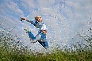 Woman jump in green grass field