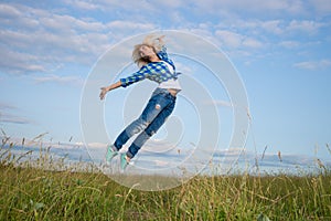 Woman jump in green grass field