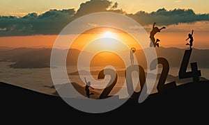 Woman jump happy new year 2024 concept, silhouette of woman jumping over barrier cliff and success with beautiful sunset