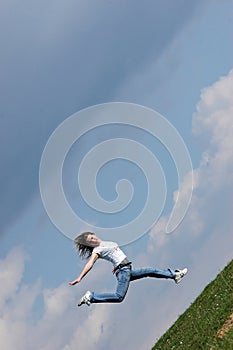 Woman jump over a grass field