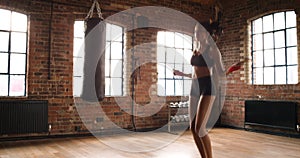 Woman, jump rope and exercise in a boxing gym with workout and sport training for wellness and health. Cardio, boxer