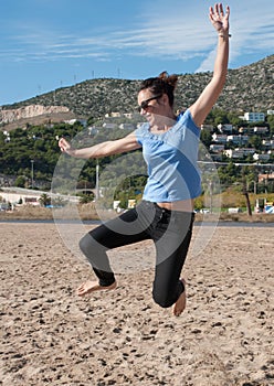 Woman jumping on the beach