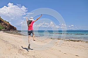 WOMAN JUMPING ON BEACH photo