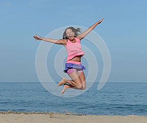 Woman jumping on beach